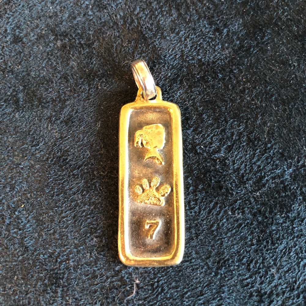 Silver and brass charm